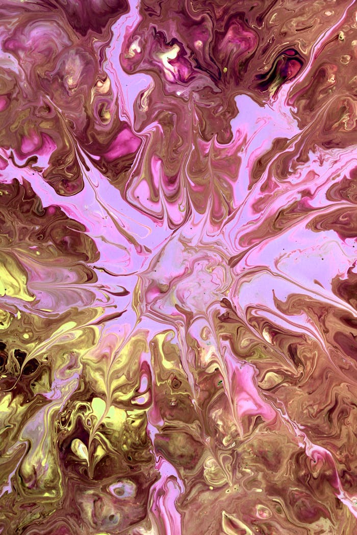 Dynamic pink and gold fluid art creating a vibrant abstract pattern, perfect for artistic displays.